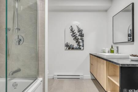 a bathroom with a shower and a sink at BLOOM - Luxe et Confort en forêt in Valcartier Station