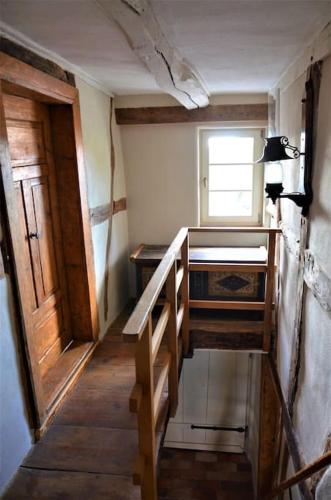 a small room with a staircase and a window at Romantische Zeitreise in historischer Käserei in Unlingen