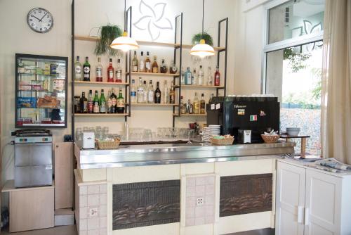 a kitchen with a bar with a counter top at Hotel B&B Gladys in Cesenatico