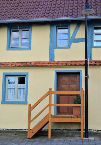 a house with a wooden bench in front of it at Romantische Zeitreise in historischer Käserei in Unlingen