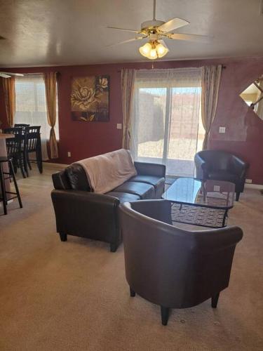 a living room with a couch and a table at I Deal Lake Powell Home 3BR, Jacuzzi, BBQ, Firepit in Page