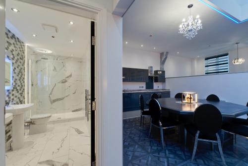 a kitchen and dining room with a table and chairs at Temple Court Cavern Quarter Apartments by Happy Days in Liverpool