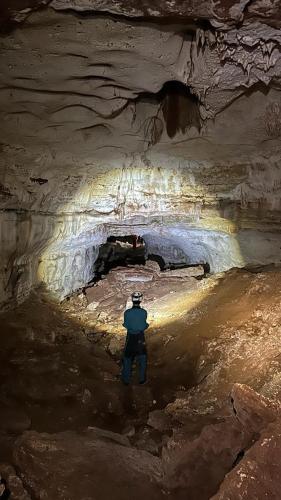 a man standing in front of a cave at GITE LA GROTTE VALLEE in Aoûtouss