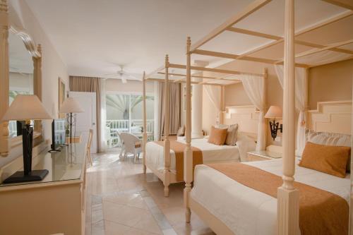 a hotel room with two beds and a balcony at Bahia Principe Grand El Portillo - All Inclusive in Las Terrenas