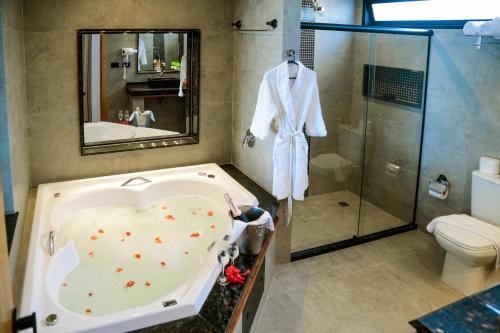 a bathroom with a bath tub and a shower at Pousada da Torre in Morro de São Paulo