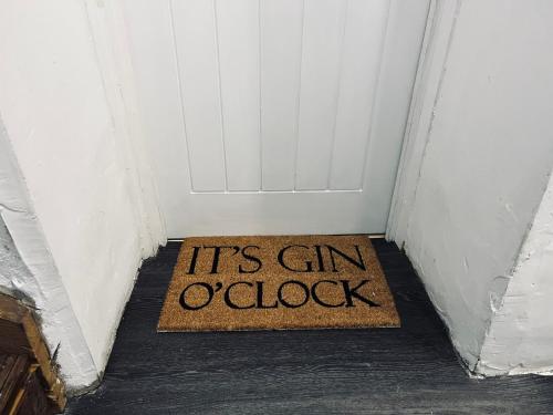 a door with a sign that says its gin octock at The Old Farmhouse in Bristol