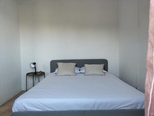 a bedroom with a white bed with two pillows at Private Pool Fazenda Terrace Villa in Silves