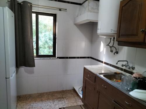 a small kitchen with a sink and a window at Private Pool Fazenda Terrace Villa in Silves