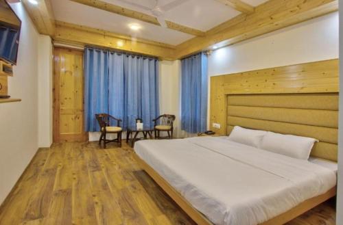 a bedroom with a large bed and a table and chairs at Hotel Ocean View By WB in Candolim