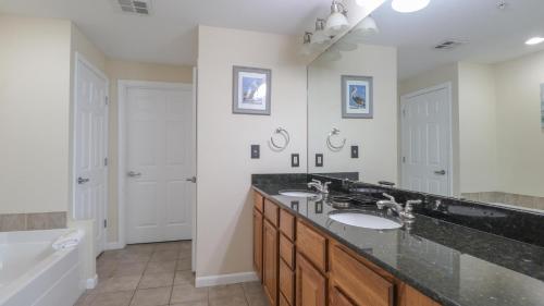 a bathroom with two sinks and a large mirror at Legacy II 403 in Gulfport