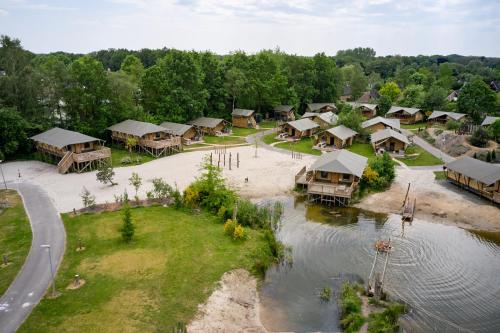 an aerial view of a resort with a beach and water at Glamping Nieuw Heeten in Nieuw-Heeten