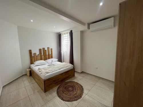 a bedroom with a bed and a window and a rug at La Vanille 2 - By EGL IMMO in Ducos