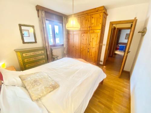 a bedroom with a bed with a pillow on it at FALORIA APARTMENT in Cortina dʼAmpezzo