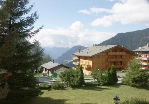 a view of a building with a mountain in the background at Amadeus 132 in Verbier