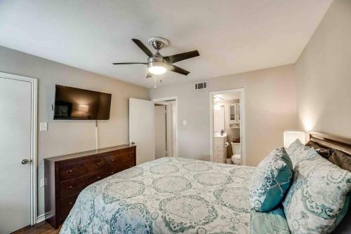 a bedroom with a bed and a ceiling fan at I12 - DFW Grd Flr Modern Furn. Condo 2BD1BA in Irving