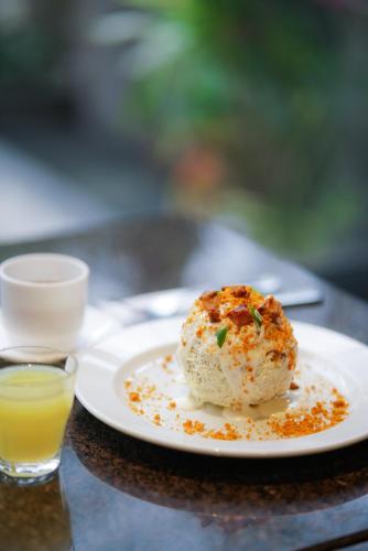 a white plate with a piece of food on a table at Hotel Marcelius in Guayaquil
