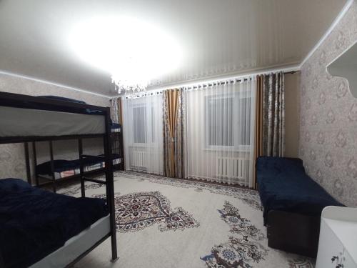 a bedroom with two bunk beds and a window at Askar Guesthouse in Karakol