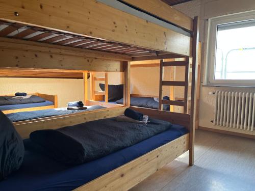 a room with three bunk beds in a house at Naturfreundehaus Grosser Wald in Gaggenau