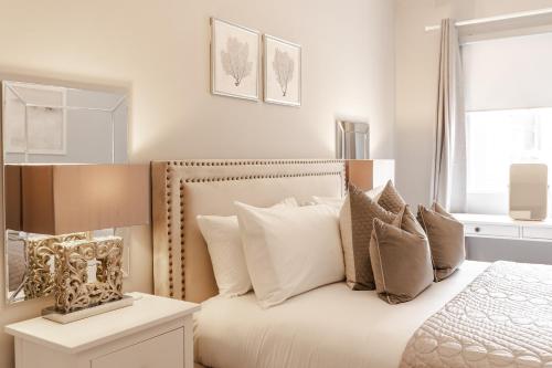 a bedroom with a bed with white sheets and pillows at Stylish & recently refurbished Chester apartment - Up to 6 in Chester