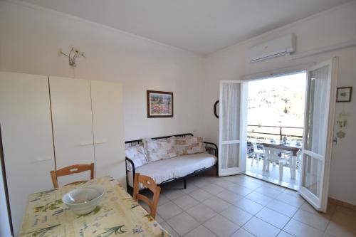 a living room with a couch and a table at Bilocale Lavanda - 100 mt. dal mare con clima in Marina di Campo