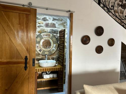 a bathroom with a sink next to a stone wall at Villa la crête in Bejaïa