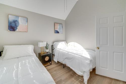 a bedroom with two beds with white sheets at Private Patio and Game Room Home in Richardson! in Richardson