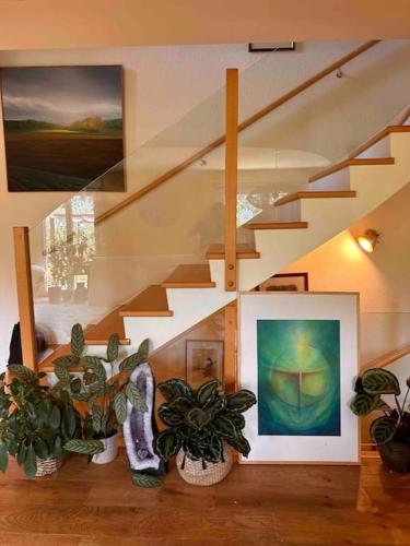a staircase with several potted plants in a room at Luxueuse oasis écologique à proximité du lac in Preverenges