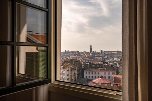 a view of a city from a window at Santa Catarina FLH Suites in Porto