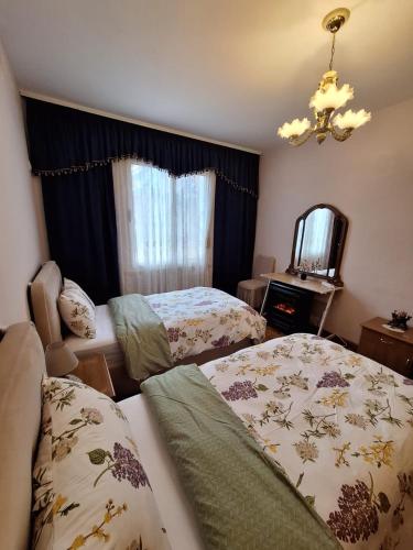 a bedroom with two beds and a mirror at CozyFlat in the middle of Tirana in Tirana