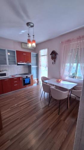 a kitchen and dining room with a table and chairs at CozyFlat in the middle of Tirana in Tirana