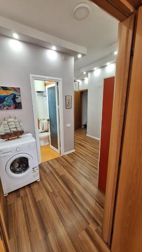 a living room with a washing machine in a room at CozyFlat in the middle of Tirana in Tirana