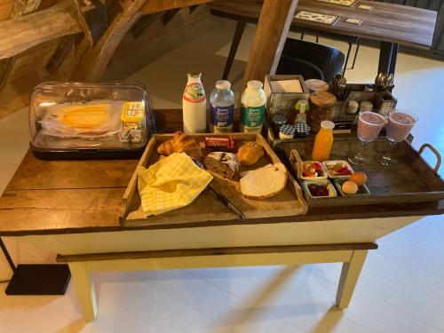 a table with a tray of food on it at Den Eijngel bed and breakfast in Boxtel