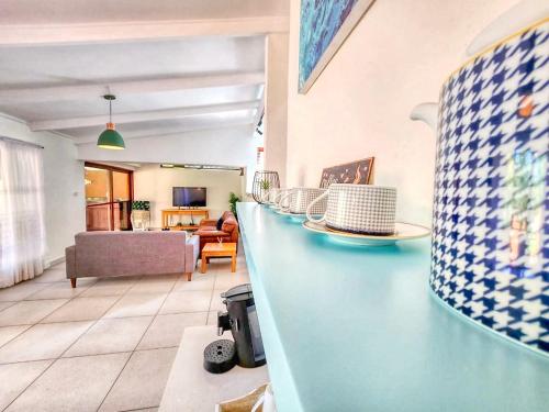 a kitchen and living room with a counter and a couch at San Lameer 2401 by Top Destinations Rentals in Southbroom