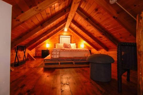 a bedroom with a bed in a wooden attic at Charming Lakeview Cabin Near Geneva-On-The-Lake! in Ashtabula