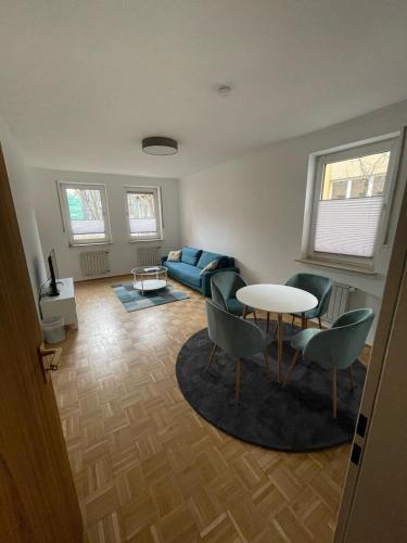 a living room with a couch and a table and chairs at NP Hotel Königshof in Dortmund