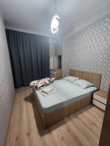 a bedroom with a large bed in a room at Dom in Tbilisi City