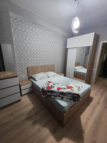 a bedroom with a bed and a large mirror at Dom in Tbilisi City