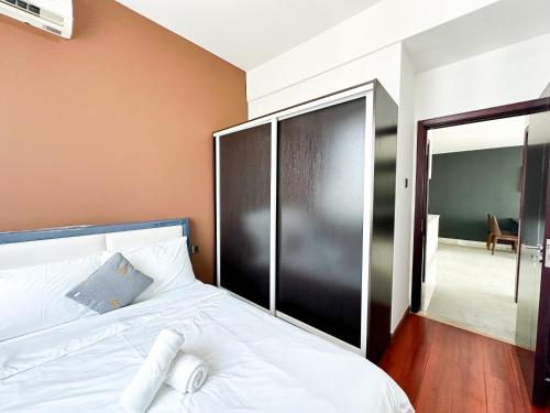 a bedroom with a bed and a sliding glass door at Urban Village Residence by Soben Homes in Phnom Penh