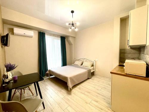 a small room with a bed and a kitchen at Parkoviy kvartal in Kharkiv