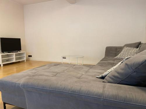 a large bed in a living room with a tv at NP Hotel Königshof in Dortmund