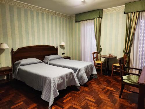 a bedroom with two beds and a table and chairs at Dimora della via Appia PRETORIA in Potenza