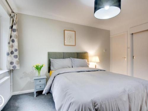 a bedroom with a large white bed and a window at The Heart of Rye in Rye