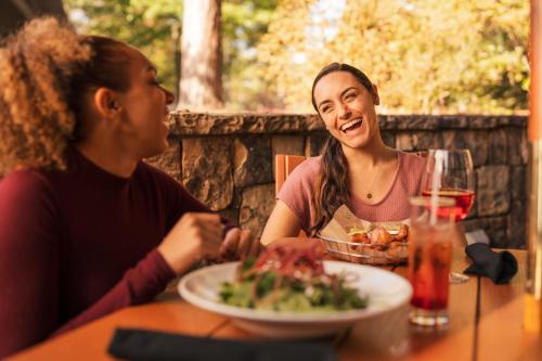 two people sitting at a table with a plate of food at Callaway Resort & Gardens in Pine Mountain