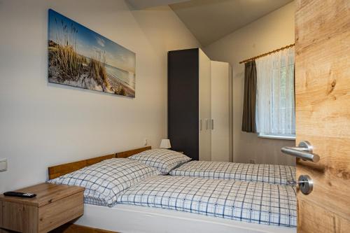 a bedroom with a bed with a plaid bedspread at Hirschenwirt in Schönbühel an der Donau