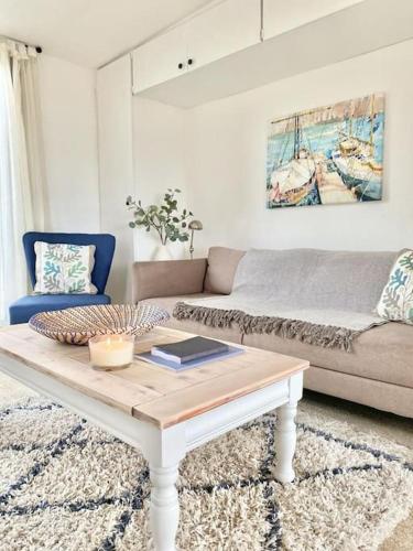 a living room with a couch and a coffee table at Driftwood in Gurnard