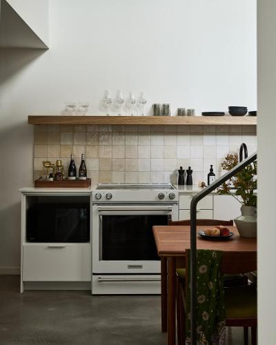 a kitchen with a white oven and a table at The Smith Hotel in Kingston