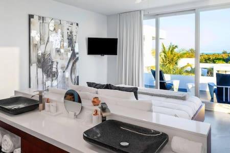a white living room with a couch and a sink at Oceanside 2 Bedroom Luxury Villa with Private Pool, 500ft from Long Bay Beach -V3 in Providenciales