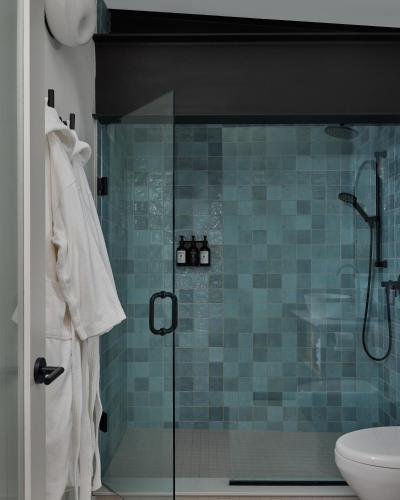a bathroom with a glass shower with a toilet at The Smith Hotel in Kingston