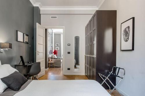 a bedroom with a bed and a desk and a chair at Casa Forneris-Splendido appartamento in stile newyorchese vicino al Valentino in Turin
