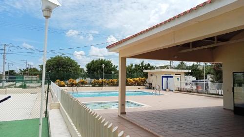 a view of a swimming pool from a house at Conjunto villas del portal dos in Soledad